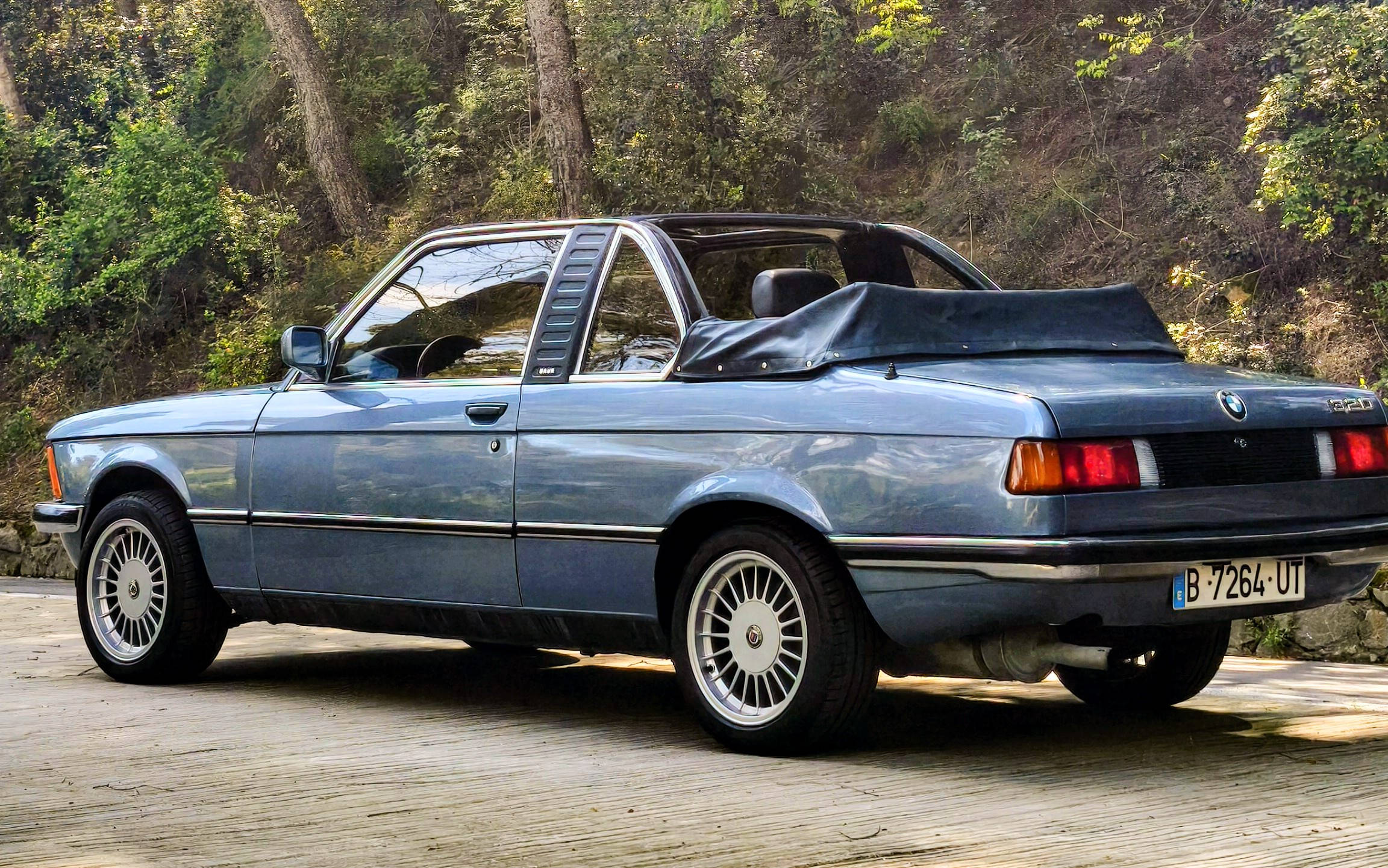 BMW E21 with its Baur roll-bar Targa visible, parked in a forest